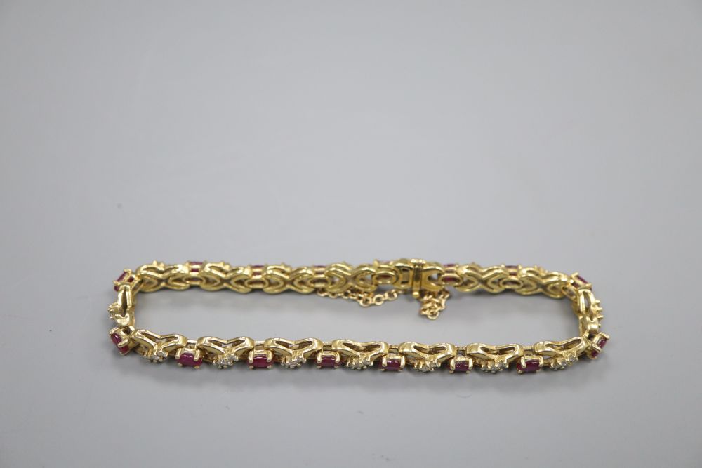 An 18ct gold diamond and ruby set bracelet, gross 21.5 grams